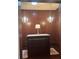 Large walk-in closet with custom cabinetry, a central island, and elegant chandelier lighting at 1802 Hartford Path, The Villages, FL 32162