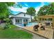 Idyllic backyard with a pool, spa, and wooden deck, featuring a pergola and lush landscaping, perfect for relaxation at 1831 Mizell Ave, Winter Park, FL 32789