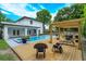 Charming backyard featuring a pool, spa, and wooden deck, complete with a pergola and outdoor seating at 1831 Mizell Ave, Winter Park, FL 32789