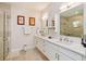 Well-lit bathroom features double vanity, large mirrors, and a glass-enclosed shower at 1831 Mizell Ave, Winter Park, FL 32789