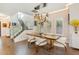 Bright dining room with hardwood floors, modern lighting, and glass-railed staircase at 1831 Mizell Ave, Winter Park, FL 32789