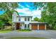 Stunning two-story modern home with stone accents and a spacious three-car garage at 1831 Mizell Ave, Winter Park, FL 32789