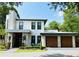 Modern two-story home showcasing stone accents, a two-car garage, and manicured landscaping at 1831 Mizell Ave, Winter Park, FL 32789