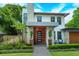 Inviting front entrance with stylish door, stone accents, and manicured landscaping at 1831 Mizell Ave, Winter Park, FL 32789