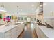 Spacious kitchen featuring white cabinets, stainless steel appliances, and a large center island at 1831 Mizell Ave, Winter Park, FL 32789