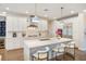 Modern kitchen with white cabinets, quartz countertops, stainless steel appliances, and island seating at 1831 Mizell Ave, Winter Park, FL 32789
