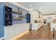 Elegant kitchen features custom cabinetry, a wine refrigerator, and stylish display shelving at 1831 Mizell Ave, Winter Park, FL 32789