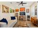Cozy home office with hardwood floors, comfortable seating, and ample display shelving at 1831 Mizell Ave, Winter Park, FL 32789