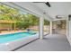 Outdoor living area with a pool, hot tub, pergola, built-in grill, and serene backyard views at 1831 Mizell Ave, Winter Park, FL 32789