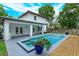 Lovely backyard showcasing a pool, spa, covered patio, and well-maintained landscaping, ideal for leisure at 1831 Mizell Ave, Winter Park, FL 32789