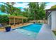 Beautiful backyard pool with a spa and wooden deck, surrounded by lush greenery, perfect for outdoor entertaining at 1831 Mizell Ave, Winter Park, FL 32789