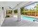 Stunning backyard oasis featuring a sparkling pool, spa, pergola, and covered patio area with modern design at 1831 Mizell Ave, Winter Park, FL 32789