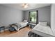 Bright bedroom with two twin beds, wood floors, ceiling fan, and a lovely lake view at 1956 Lake Atriums Cir # 146, Orlando, FL 32839