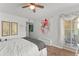 Comfortable bedroom including a ceiling fan and access to the private screened-in patio at 1956 Lake Atriums Cir # 146, Orlando, FL 32839