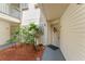 Welcoming entrance with decorative wreath, lush greenery, and charming curb appeal at 1956 Lake Atriums Cir # 146, Orlando, FL 32839