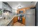 Functional kitchen featuring granite countertops, stainless steel appliances and decorative backsplash at 1956 Lake Atriums Cir # 146, Orlando, FL 32839