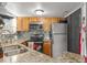 Efficient kitchen has stainless steel appliances, granite countertops and a patterned backsplash at 1956 Lake Atriums Cir # 146, Orlando, FL 32839