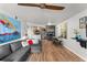 Comfortable living room features an open layout to the kitchen with modern decor and wood-look floors at 1956 Lake Atriums Cir # 146, Orlando, FL 32839