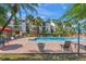 Inviting community pool area with palm trees, lounge chairs, and well-maintained landscaping at 1956 Lake Atriums Cir # 146, Orlando, FL 32839