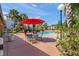 Community pool area featuring comfortable seating, shade umbrellas, and lush greenery at 1956 Lake Atriums Cir # 146, Orlando, FL 32839