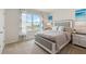 Bright bedroom with a large window, neutral colors, and elegant decor, creating a serene and inviting space at 2155 Kalin Way, Tavares, FL 32778