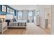 Inviting bedroom with blue accent wall, soft natural light, and stylish furnishings, creating a tranquil retreat at 2155 Kalin Way, Tavares, FL 32778