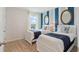 bedroom featuring two twin beds, beach themed decor, and bright blue and white accents at 2155 Kalin Way, Tavares, FL 32778