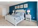 Comfortable bedroom featuring a striking blue accent wall, plush carpeting, and stylish bedside tables at 2155 Kalin Way, Tavares, FL 32778