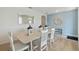 Dining room with seating for six, decorative mirrors, modern flooring, and soft, inviting colors at 2155 Kalin Way, Tavares, FL 32778