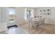 Open dining room showcasing a table with seating for six, natural light, and modern entryway at 2155 Kalin Way, Tavares, FL 32778