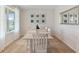 Comfortable dining room with large windows and natural light, a table with six chairs, and modern artwork at 2155 Kalin Way, Tavares, FL 32778