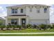 Two-story home with a two-car garage, complemented by a well-manicured lawn and inviting landscaping at 2155 Kalin Way, Tavares, FL 32778
