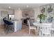 Open-concept kitchen featuring stainless steel appliances, granite countertops, a breakfast bar, and casual dining area at 2155 Kalin Way, Tavares, FL 32778