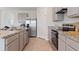 Bright kitchen features granite counters, stainless appliances, and a stainless steel refrigerator at 2155 Kalin Way, Tavares, FL 32778