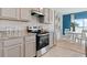 Well-lit kitchen with stainless steel oven, granite counters, ample cabinetry, and a breakfast nook at 2155 Kalin Way, Tavares, FL 32778