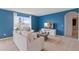 Modern living room featuring comfortable seating, a large window, and bright blue accent wall at 2155 Kalin Way, Tavares, FL 32778