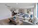 Open concept living room and kitchen showcasing modern furniture, decor, and stainless steel appliances at 2155 Kalin Way, Tavares, FL 32778