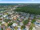 Wide aerial shot of a residential area showcasing tree-lined streets and diverse home styles with solar panels in a well-kept neighborhood at 2239 Meadowmouse St, Orlando, FL 32837