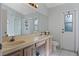 Bathroom featuring double sinks, shower, and exterior door at 2239 Meadowmouse St, Orlando, FL 32837
