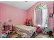 Bright bedroom featuring a bed and arched window at 2239 Meadowmouse St, Orlando, FL 32837