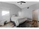 Bedroom with a bed, vaulted ceiling, ceiling fan, rug and two windows at 2239 Meadowmouse St, Orlando, FL 32837