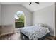 Bright bedroom featuring a vaulted ceiling, arch window, and hardwood floors at 2239 Meadowmouse St, Orlando, FL 32837