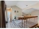 Hallway featuring wood railing, plant, and wood-look floors at 2239 Meadowmouse St, Orlando, FL 32837