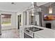Modern kitchen with white cabinets, stainless steel appliances, white countertops, and wood flooring at 2239 Meadowmouse St, Orlando, FL 32837