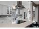 Modern kitchen with stainless steel appliances, white cabinets, quartz countertops, and stylish pendant lighting at 2239 Meadowmouse St, Orlando, FL 32837
