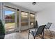 Screened patio with wood-look tile and two chairs, leading to a backyard at 2239 Meadowmouse St, Orlando, FL 32837