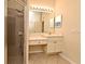 Well-lit bathroom featuring a vanity, walk-in shower, and neutral tile flooring at 2503 Squaw Crk, Clermont, FL 34711