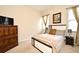 Comfortable bedroom with neutral carpet, decorative pillows, and windows with natural light at 2503 Squaw Crk, Clermont, FL 34711
