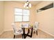Cozy breakfast nook features a glass table, floral chairs, and a window with natural light at 2503 Squaw Crk, Clermont, FL 34711