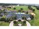 Aerial view of a resort-style clubhouse with pool, putting green, parking, and meticulously landscaped grounds at 2503 Squaw Crk, Clermont, FL 34711